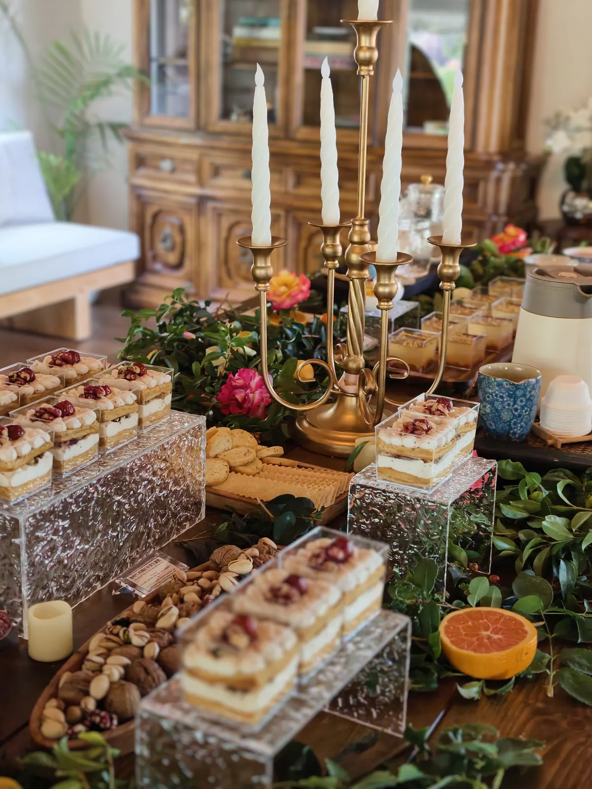 Grazing-style dessert table with candles and dessert cups