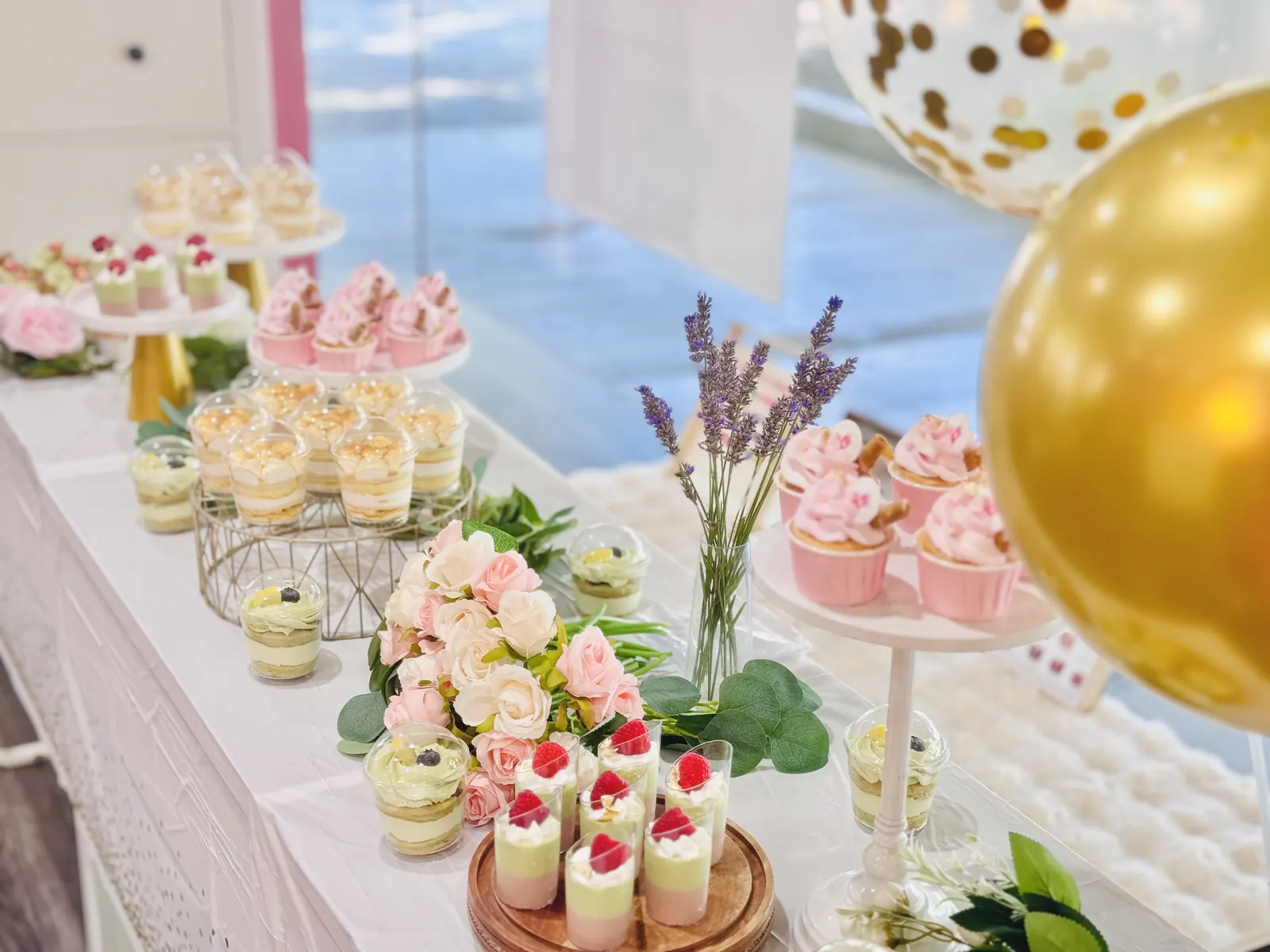 Mini desserts with flowers and a gold balloon