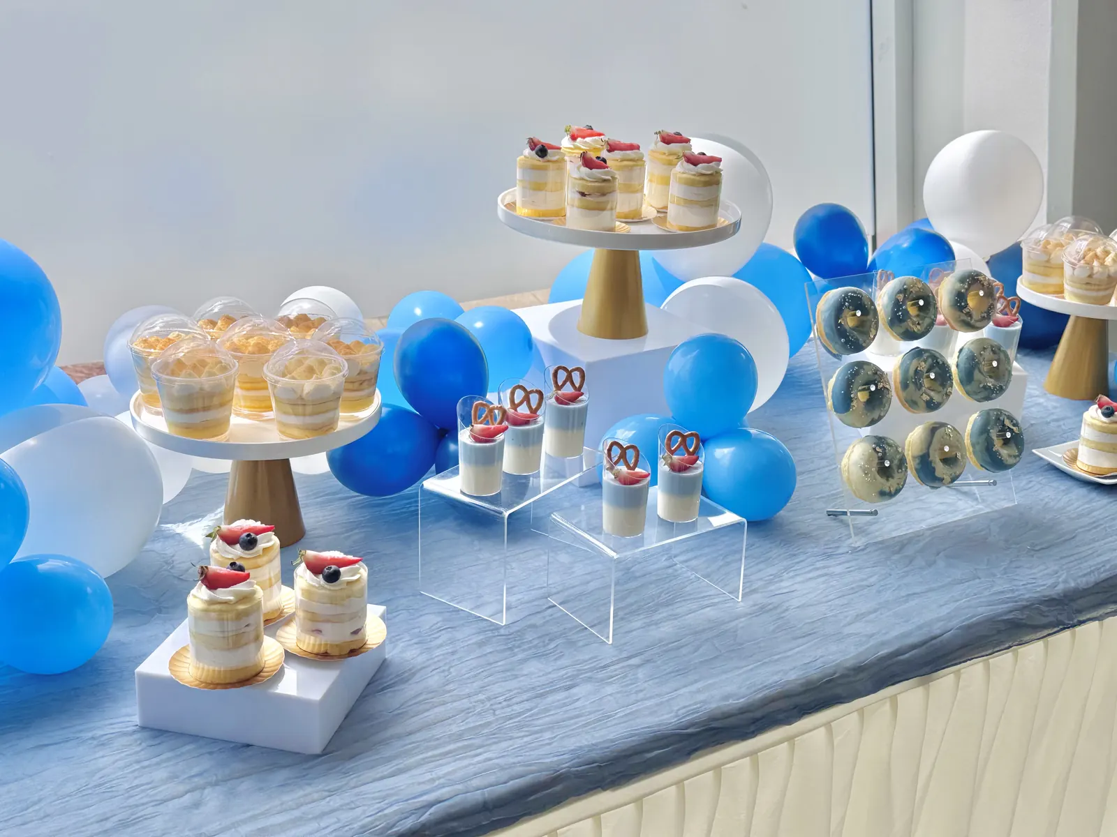 Dessert display with blue and white balloons