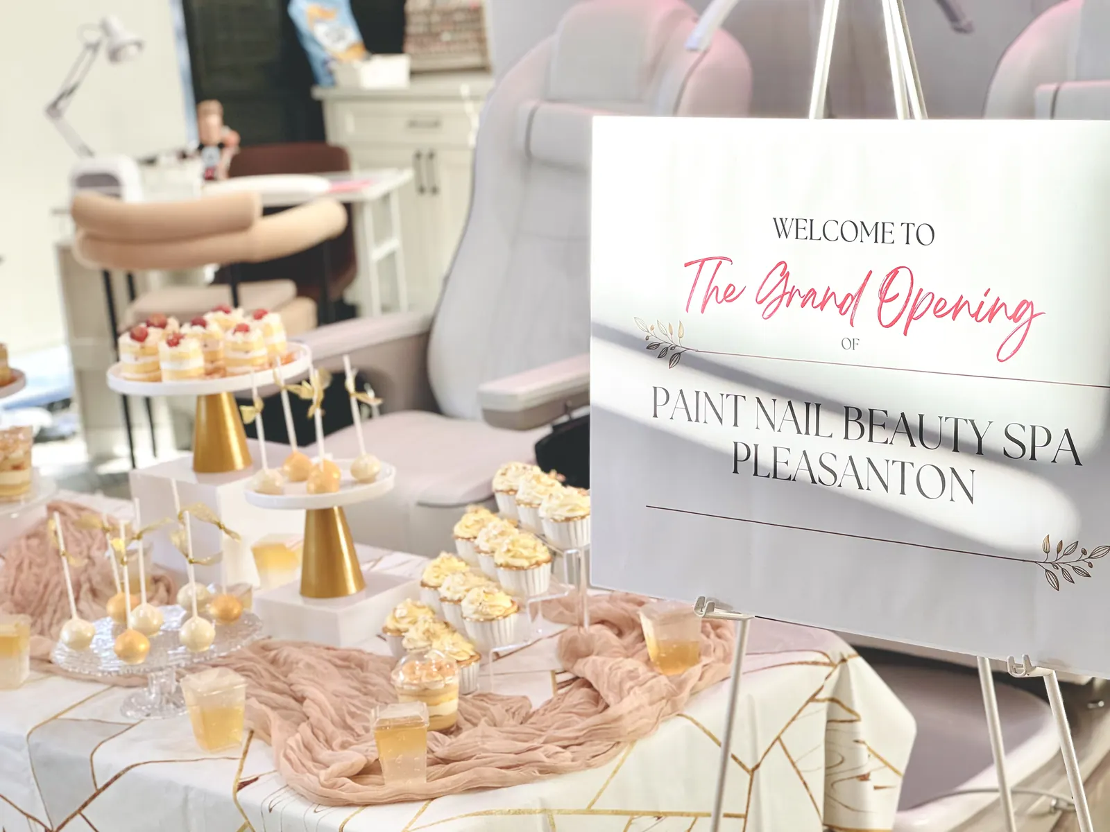 Grand opening dessert table beside a welcome sign