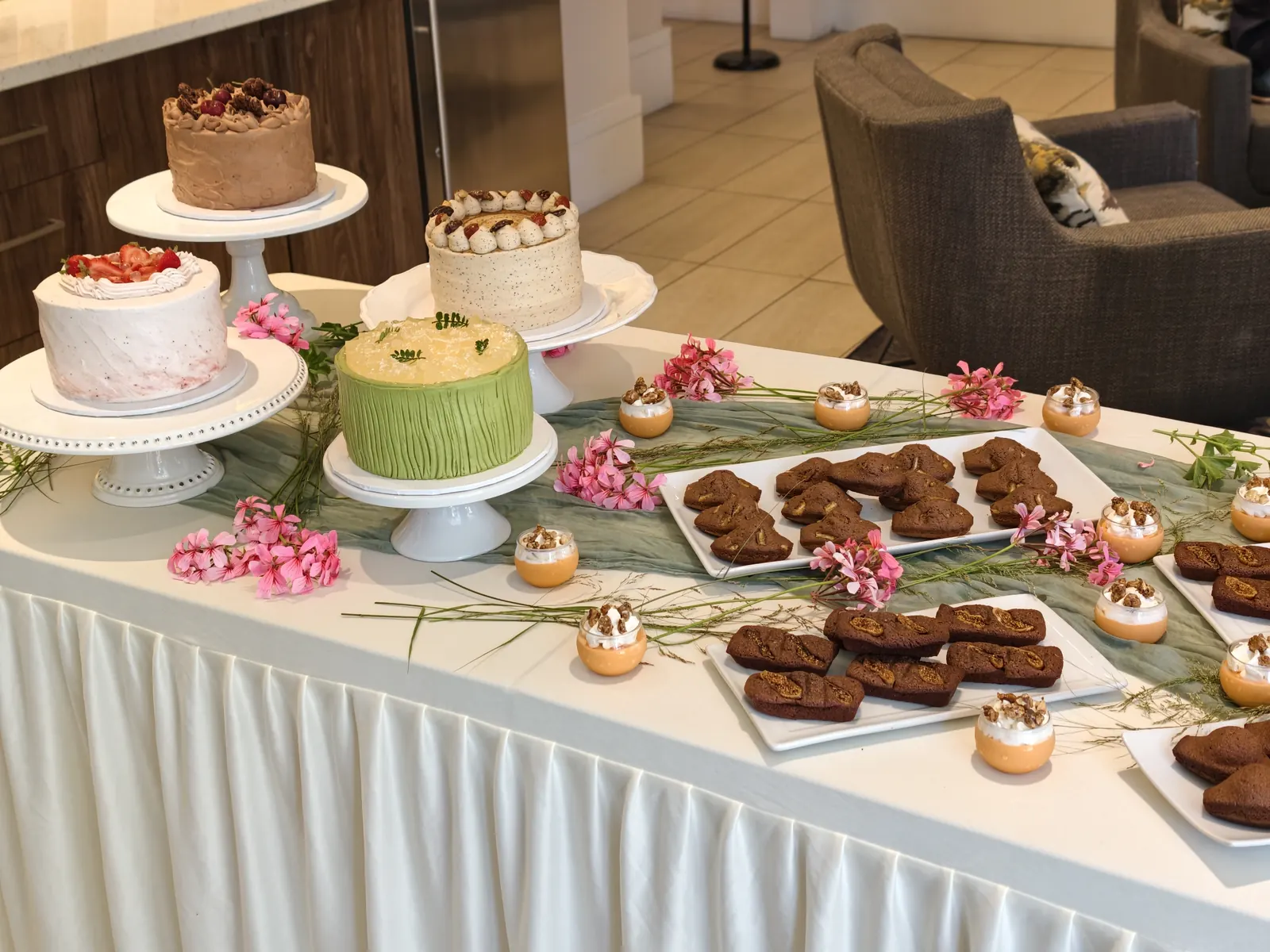 Buffet of cakes, brownies and pastries on a white table