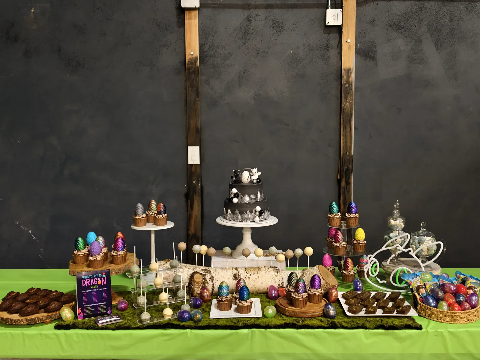 Dragon-themed dessert table with colorful egg treats